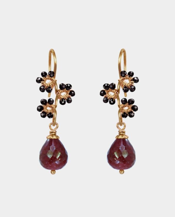 Earrings with bevelled rubies with droplet shapes and flowers decorated from black spinel gemstones on sterling silver plated with 18 carat gold without nickel