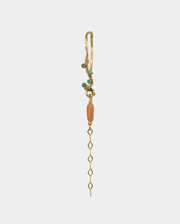 Elaborate earring in sculptural Scandinavian design with coral and light green emeralds from the jewelry shop in Copenhagen