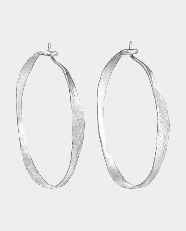 Large silver hoops from jewelery shop in Copenhagen C - processed by hand in a rustic balance that captivates women who want quality jewelery in silver