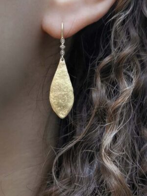 leaf shaped hammerede earrings and white topaz model