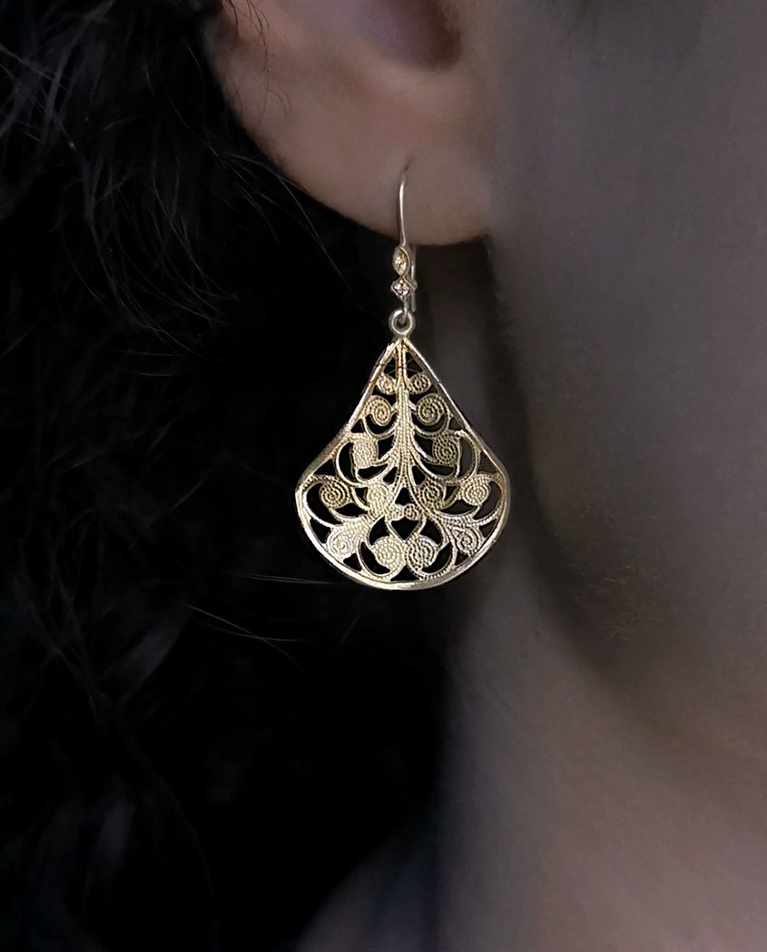 earring with filigree pattern model close up