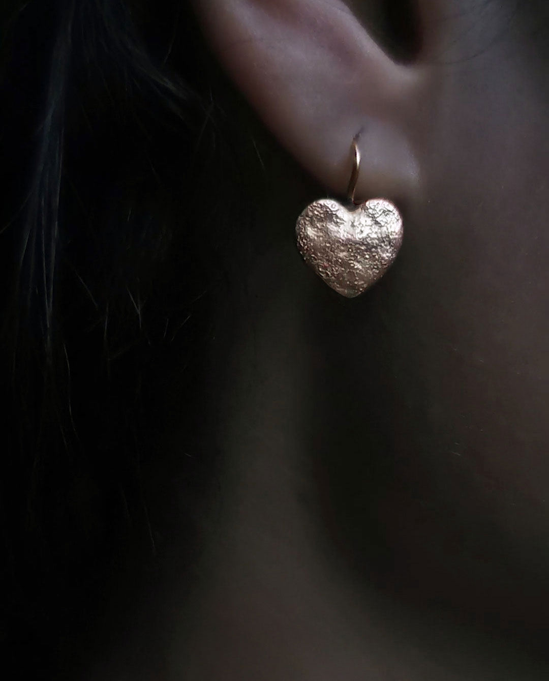 earring with hammered heart close up