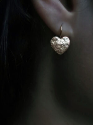 earring with hammered heart close up