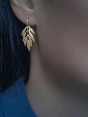 olive branch earring close up
