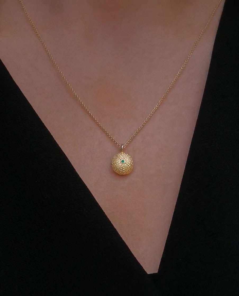 sea urchin necklace with green emerald close up