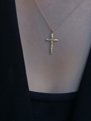 cross with light blue apatite model close up