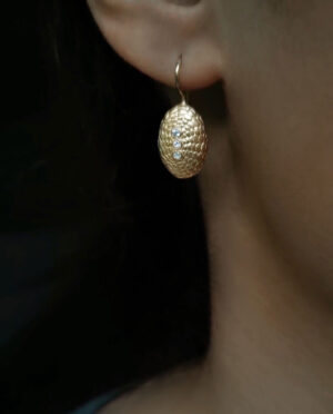 earring with turtle sea urchin close up