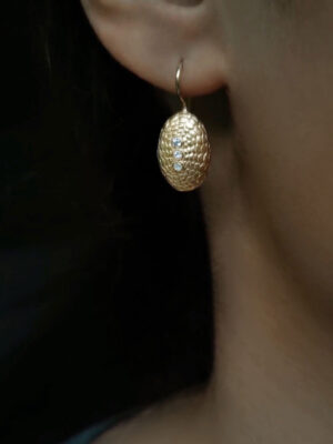 earring with turtle sea urchin close up