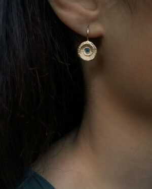 earrings shaped as sea snails close up