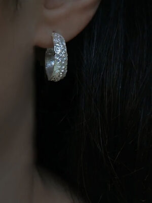 silver hoops with rustic pattern close up