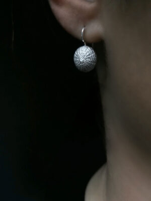 silver turtle sea urchin with white topaz close up