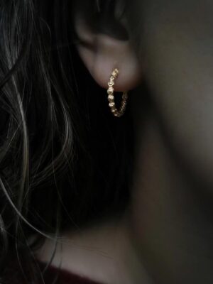 Close-up of the Allegra earring with an archaic pattern