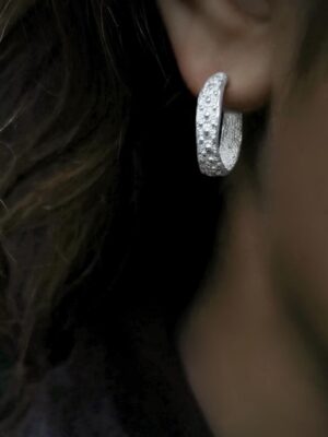 renata silver hoop with small tactile details close up